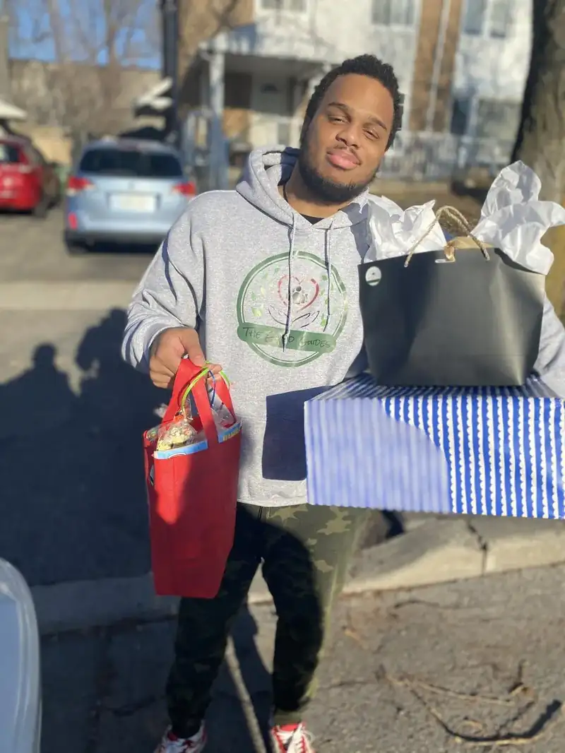 Project Manager Chaz handing out gifts and treat bags in the community